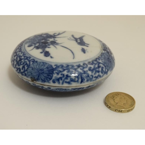 419 - A Chinese blue and white ink box and cover , decorated with butterflies and flowers to lid amid a sc... 