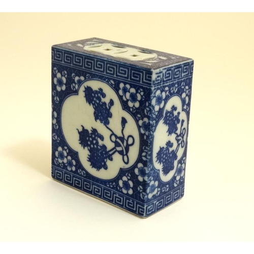 421 - A Chinese pierced blue and white flower brick/grasshopper box with stylised foliate decoration. With... 