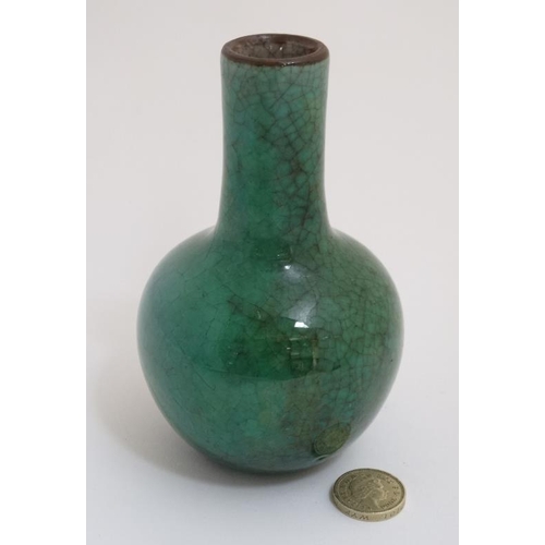 422 - A small Chinese apple green Crackle Glaze bottle neck vase. 5'' high.