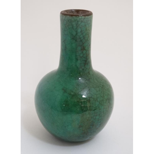 422 - A small Chinese apple green Crackle Glaze bottle neck vase. 5'' high.