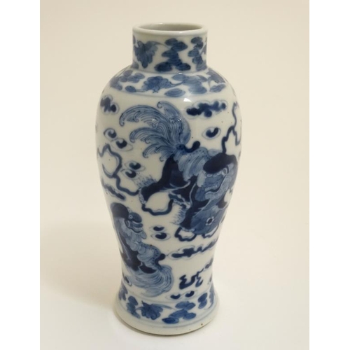 425 - A Chinese blue and white vase decorated with dogs of fo with pearls of wisdom amongst scrolling clou... 