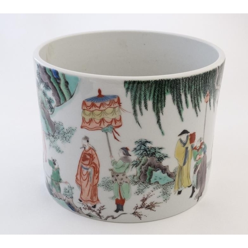 426 - A large Chinese famille rose brush pot decorated with figures and officials and cattle in a rocky la... 