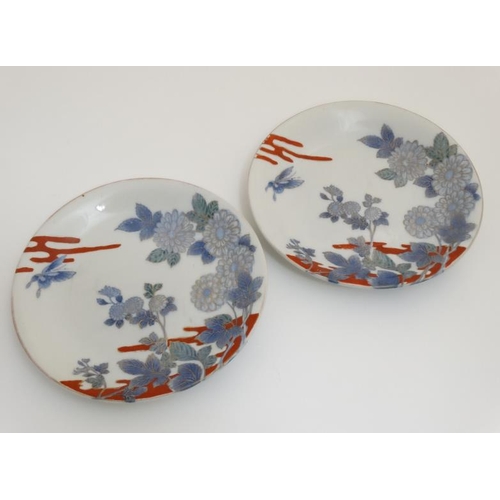 433 - A pair of 19thC Japanese Arita Shiroiwa plates , decorated with flowers and butterflies in blue and ... 