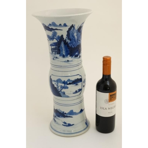 435 - A Chinese blue and white 'Gu' vase with flared rim ,decorated with figures and boats on a lake amids... 