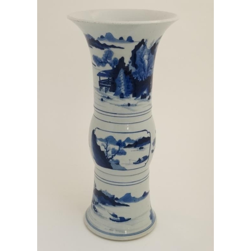 435 - A Chinese blue and white 'Gu' vase with flared rim ,decorated with figures and boats on a lake amids... 