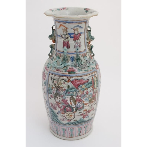 436 - A large Chinese Canton famille rose vase of baluster form, having opposing figural panels decorated ... 