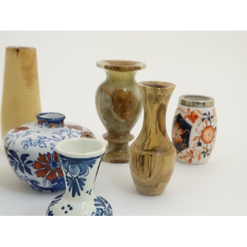 439 - A collection of 14 small and miniature vases to include blue and white delft , Oriental, wooden and ... 