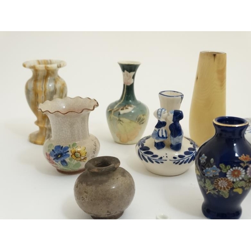 439 - A collection of 14 small and miniature vases to include blue and white delft , Oriental, wooden and ... 