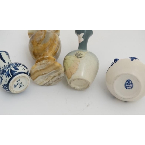 439 - A collection of 14 small and miniature vases to include blue and white delft , Oriental, wooden and ... 