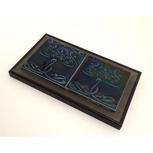 449 - A pair of framed Art Nouveau majolica style tiles in dark blue decorated with stylised flowers. Each... 