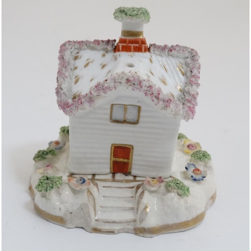 452 - A 19thC Staffordshire Cottage pastille burner, having bocage and floral details. 3 3/4'' high.