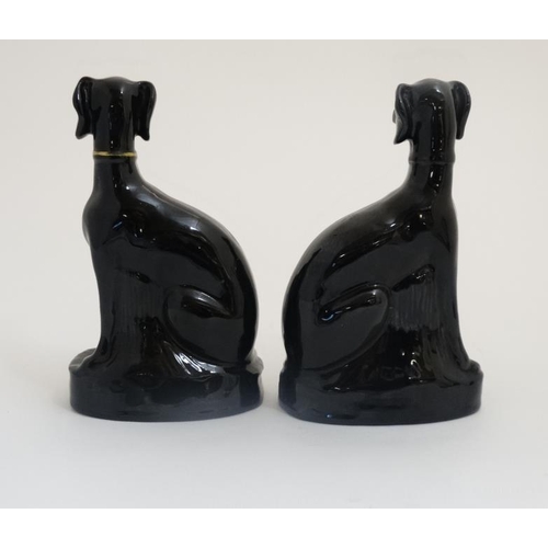 456 - A pair of Jackfield Black Victorian Staffordshire pottery seated greyhounds , having gilt coloured c... 