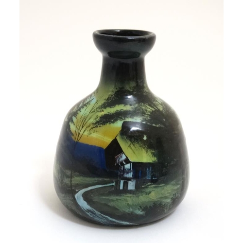 462 - A small c1900 continental pottery vase decorated with rural building in a mountainous landscape in s... 