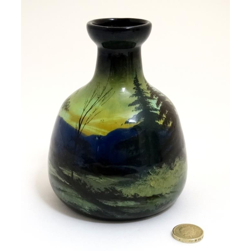 462 - A small c1900 continental pottery vase decorated with rural building in a mountainous landscape in s... 