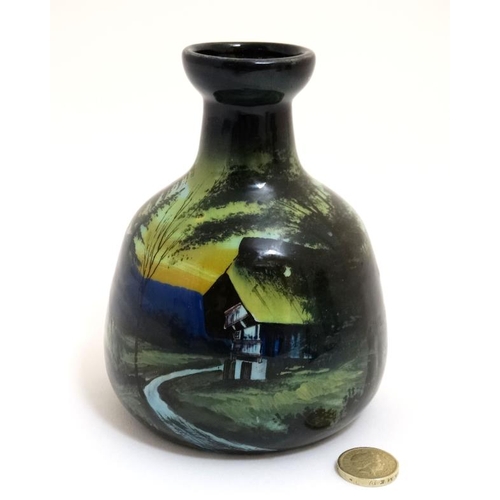 462 - A small c1900 continental pottery vase decorated with rural building in a mountainous landscape in s... 