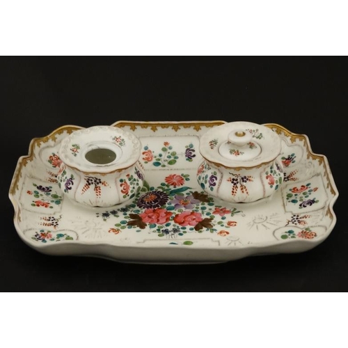 463 - A French Samson style standish comprising two inkwells, decorated with polychrome flowers on a white... 