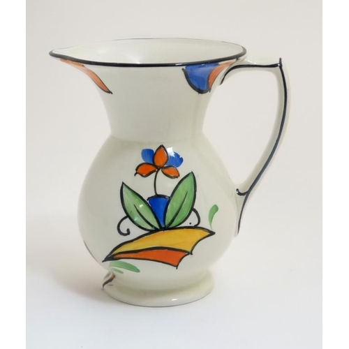 469 - A 1930s Beswick 'Clarice Cliff' style jug , decorated with stylised flowers in orange, blue and gree... 