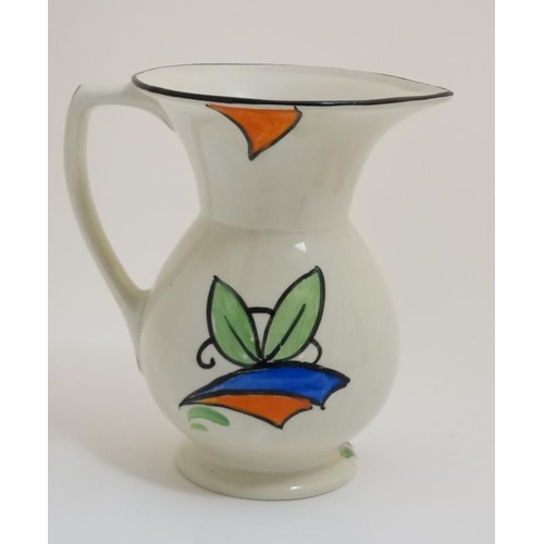 469 - A 1930s Beswick 'Clarice Cliff' style jug , decorated with stylised flowers in orange, blue and gree... 