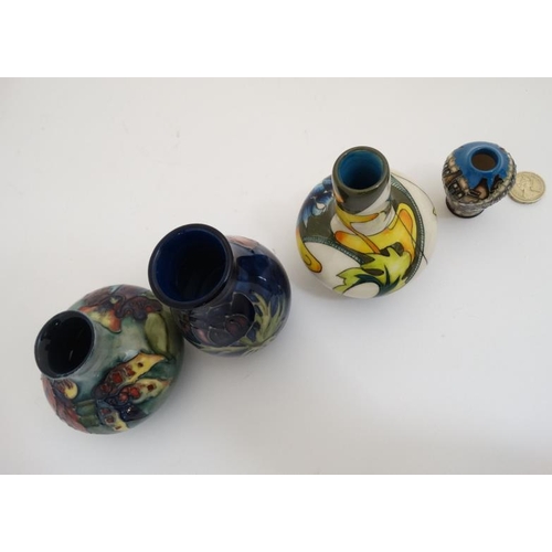 471 - Two Moorcroft vases , to include an 'orchid vase' on a pale blue ground and a '' poppy '' vase and a... 