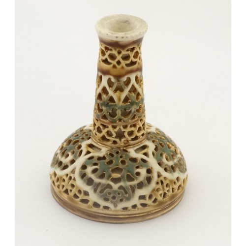 476 - A c1900 Zsolnay miniature reticulated bottle vase, decorated in green and gilt colours of a cream gr... 