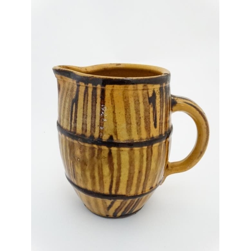 477 - An early / mid 20th slipware pottery banded ale jug , bears indistinct pencil marks to base. 6 1/2''... 