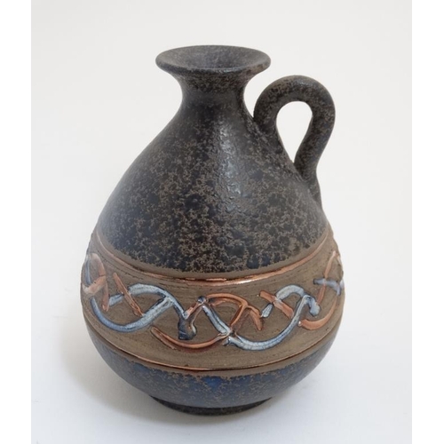 486 - A Spanish Mejias Polonio Pottery pitcher, decorated with decorative band with lustre detail and loop... 