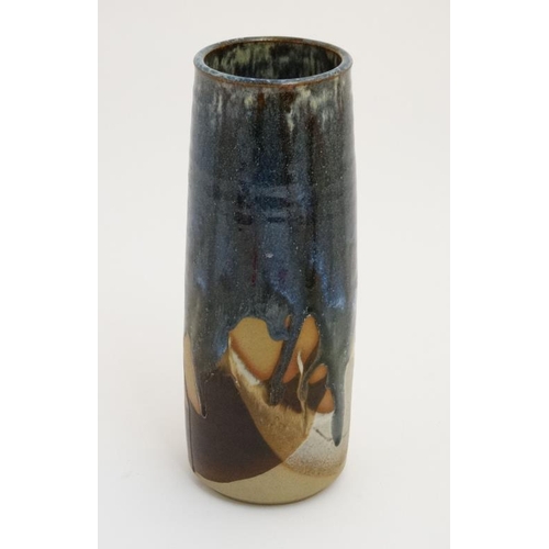 492 - A Canterbury Cotton Studio Pottery cylinder vase, decorated in shades of blue and brown , bears sign... 