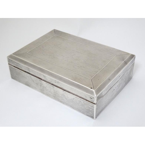 512 - An Art Deco silver table top cigarette box with engine turned decoration. Hallmarked Birmingham 1936... 