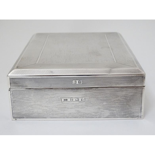 512 - An Art Deco silver table top cigarette box with engine turned decoration. Hallmarked Birmingham 1936... 