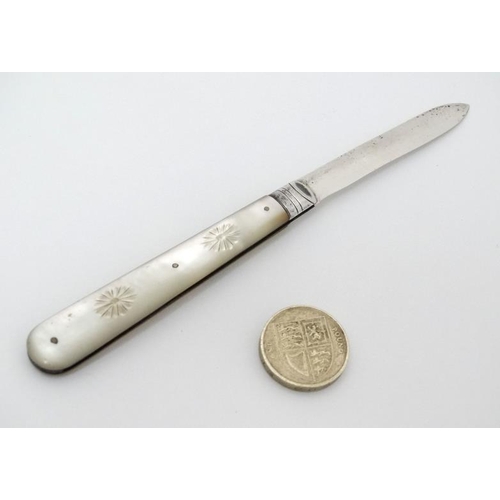 514 - A silver folding fruit knife with mother of pearl handle having engraved decoration Hallmarked Sheff... 