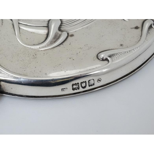 517 - An Art Nouveau silver hand mirror with floral and scroll decoration. Hallmarked London 1905 maker Ch... 