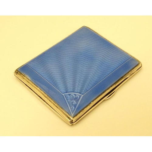 520 - An Art Deco silver cigarette case with engine turned and blue guilloché enamel decoration. Hallmarke... 