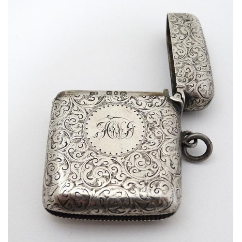 536 - A silver vesta case with engraved decoration with hinged lid and striker under hallmarked Birmingham... 