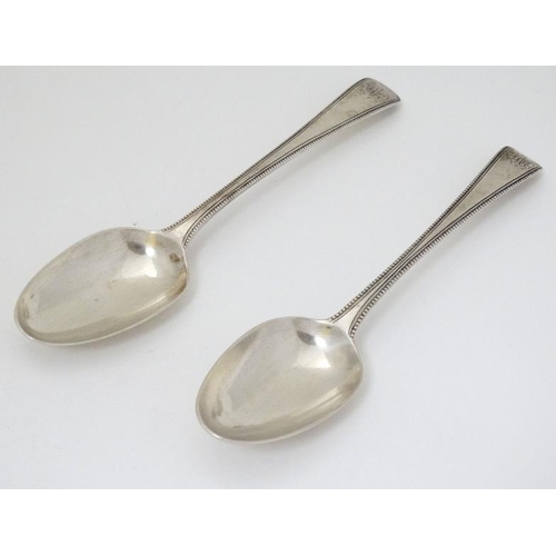 540 - A pair of 18thC silver bead edged table spoons hallmarked London 1777 maker Thomas Chawner  8 1/2'' ... 