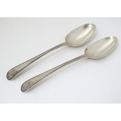 540 - A pair of 18thC silver bead edged table spoons hallmarked London 1777 maker Thomas Chawner  8 1/2'' ... 