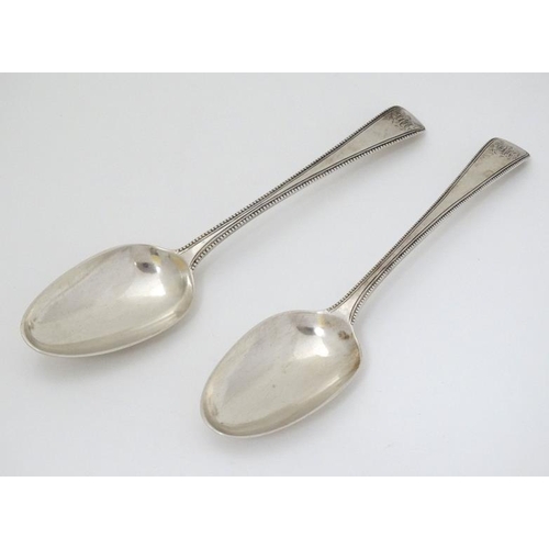 540 - A pair of 18thC silver bead edged table spoons hallmarked London 1777 maker Thomas Chawner  8 1/2'' ... 