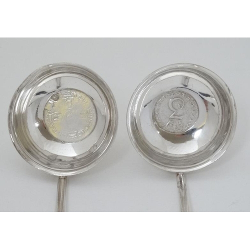 549 - Two  white metal toddy ladles with inset coins to base and whale bone twist handles. 8 1/2'' long