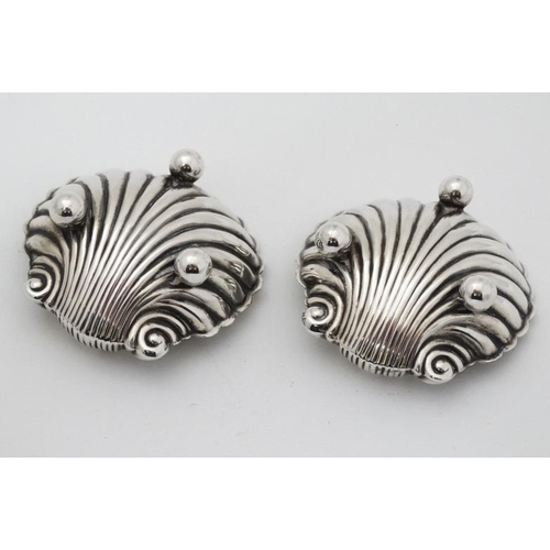 562 - A pair of silver salts formed as scallop shells. Hallmarked Birmingham 1898 maker Matthew John Jesso... 