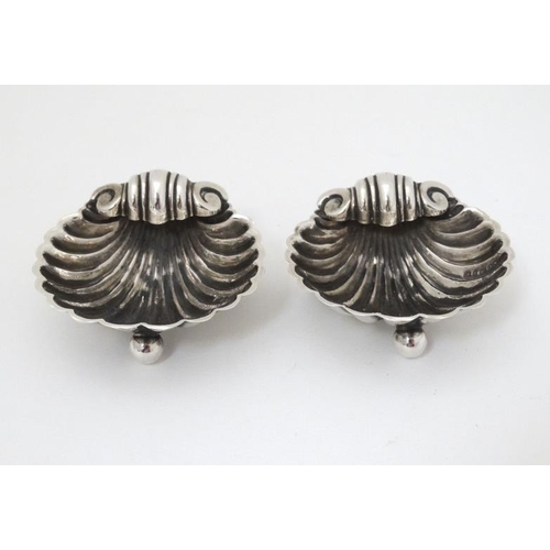 562 - A pair of silver salts formed as scallop shells. Hallmarked Birmingham 1898 maker Matthew John Jesso... 