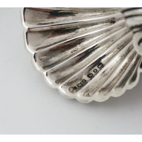 562 - A pair of silver salts formed as scallop shells. Hallmarked Birmingham 1898 maker Matthew John Jesso... 