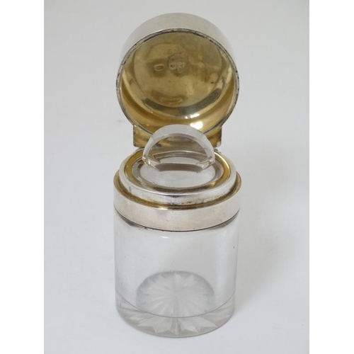 565 - A glass scent bottle and stopper with silver mounts and hinged lid. Hallmarked London 1893 maker Sam... 