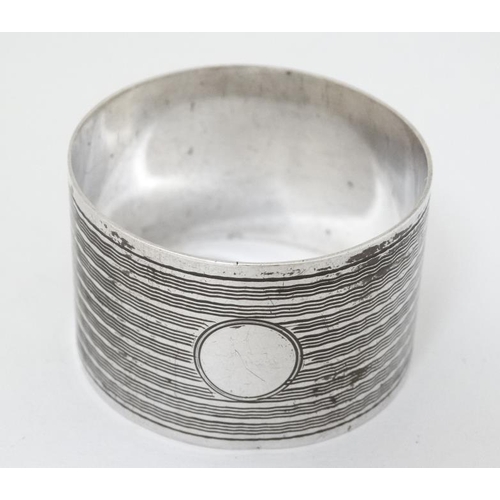 574 - An Art Deco silver napkin ring with engine turned decoration Hallmarked Birmingham 1944 maker E J Ho... 