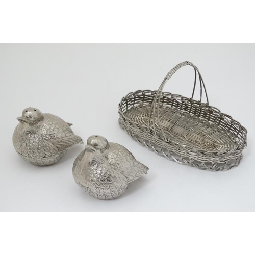 580 - A novelty cruet set comprising a pair of salt and pepper pots formed as chicks in a basket. 6'' wide