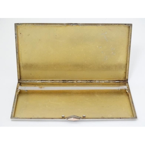 587 - An Art Deco cigarette case with engine turned decoration and gilt detail. 6'' x 3 1/2'' x 1 /4'' (27... 