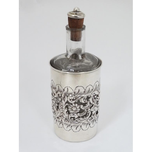 590 - A glass cologne bottle with embossed and pierced silver cover hallmarked Birmingham 1904 maker Willi... 