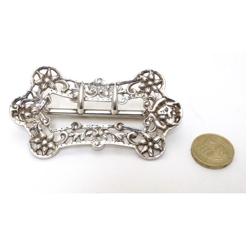 592 - A Victorian silver belt buckle with floral and scroll etc decoration. Hallmarked Birmingham 1894 mak... 