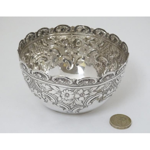 593 - A silver bowl with embossed decoration hallmarked Sheffield 1895 maker John Round & Son Ltd. 4 1/2''... 