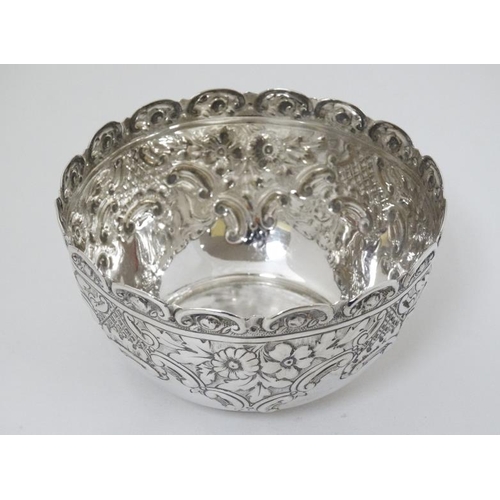 593 - A silver bowl with embossed decoration hallmarked Sheffield 1895 maker John Round & Son Ltd. 4 1/2''... 