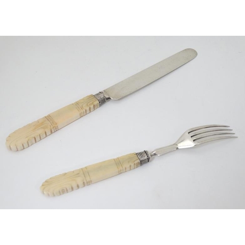 595 - A Wm IV silver fruit knife and fork with carved ivory handles. Hallmarked Sheffield 1832 maker J.B. ... 