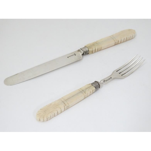 595 - A Wm IV silver fruit knife and fork with carved ivory handles. Hallmarked Sheffield 1832 maker J.B. ... 